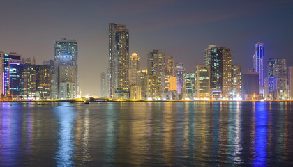 Fototapeta na wymiar Night landscape of the embankment of the emirate of Sharjah, United Arab Emirates.