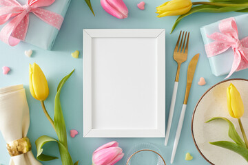 Mother's Day concept. Top view photo of vertical photo frame gift boxes plate cutlery knife fork fabric napkin yellow pink tulips and colorful hearts on pastel blue background with blank space