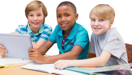 Cute pupils using tablet computer in library