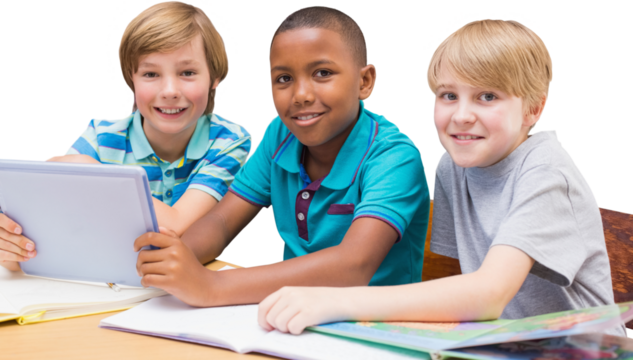 Cute pupils using tablet computer in library
