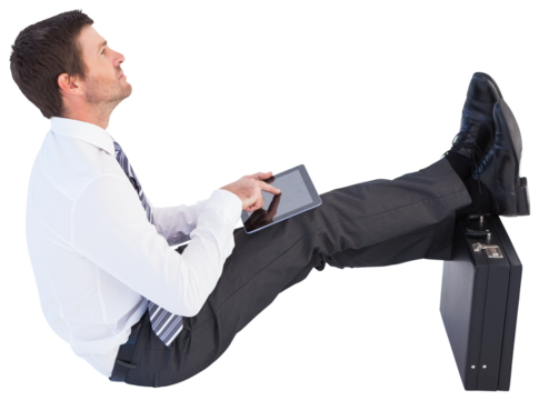 Businessman sitting with feet up while using his tablet - Powered by Adobe