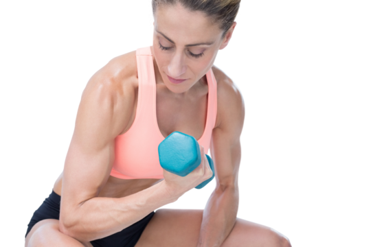 Strong woman doing bicep curl with blue dumbbell