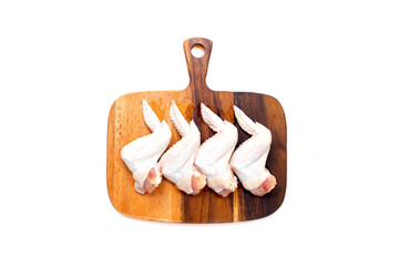 Fresh raw chicken wings on wooden cutting board