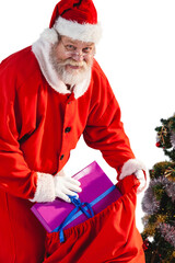 Santa Claus putting Christmas presents in Christmas bag