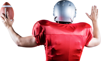 Rear view of American football player gesturing while holding ball