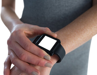 Mid section of businesswoman adjusting smart watch