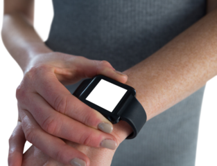 Mid section of businesswoman adjusting smart watch