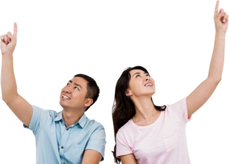 Happy young couple pointing up