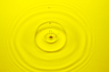 Golden water ripple and water drop.