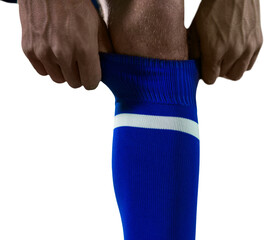 Low section of football player pulling his socks