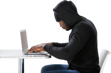 Side view of male hacker using laptop