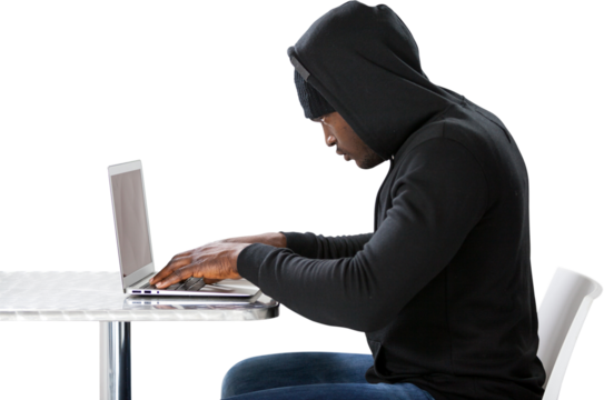 Side view of male hacker using laptop 