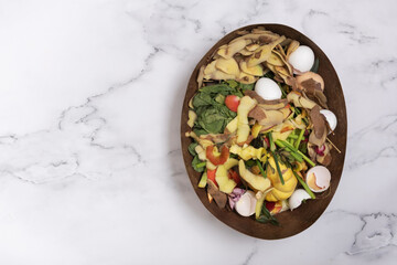 Organic garbage for compost on a marble background. Composting concept flat lay, top view