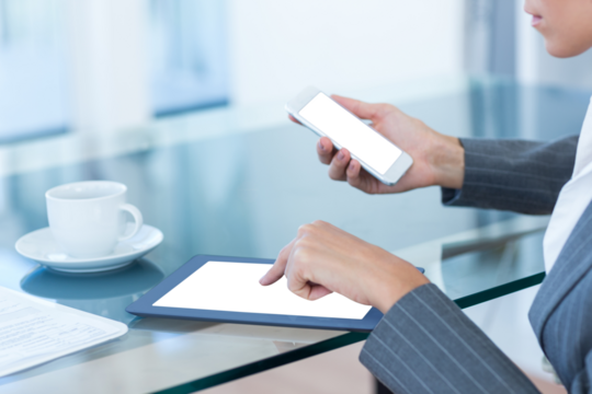 Businesswoman using digital tablet and mobile phone
