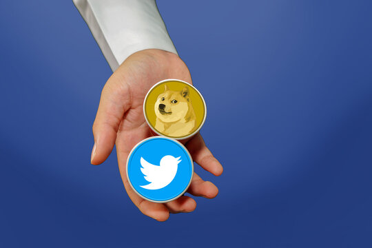 A man holding the old Twitter logo and the new Twitter logo Dogecoin in his hand