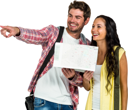 Smiling couple holding map while pointing away