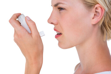 Asthmatic pretty blonde woman using inhaler - obrazy, fototapety, plakaty