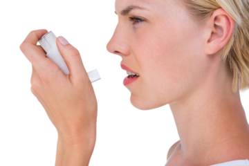Asthmatic pretty blonde woman using inhaler