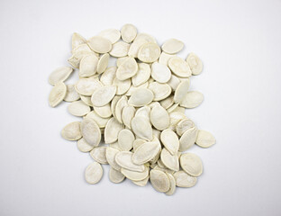 Pumpkin seeds. White dried natural pumpkin seeds on a white background.