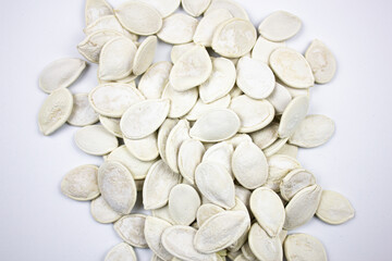 Pumpkin seeds. White dried natural pumpkin seeds on a white background.
