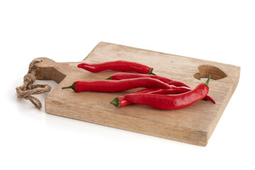 Red peppers on a wooden cutting board