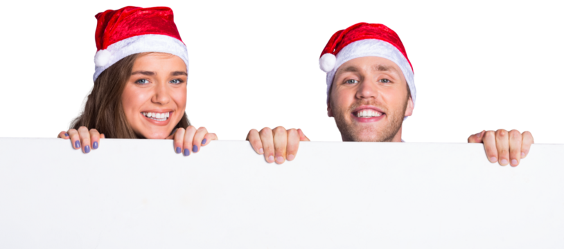Couple in santas hats with blank board
