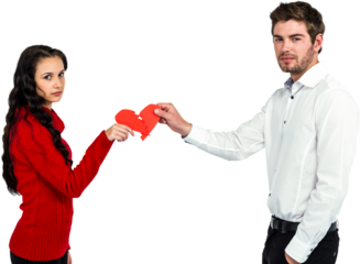 Portrait of couple holding red cracked heart shape