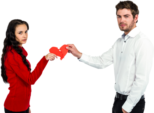 Portrait of couple holding red cracked heart shape 