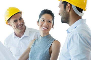 Happy architect discussing over blueprint