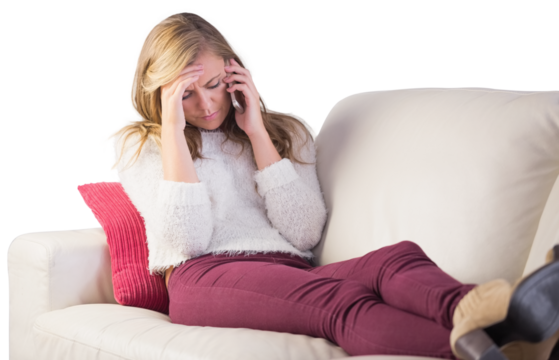 Pretty blonde getting a headache on the couch