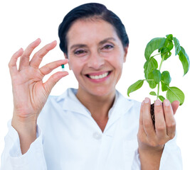 Portrait of scientist holding basil plant and pill