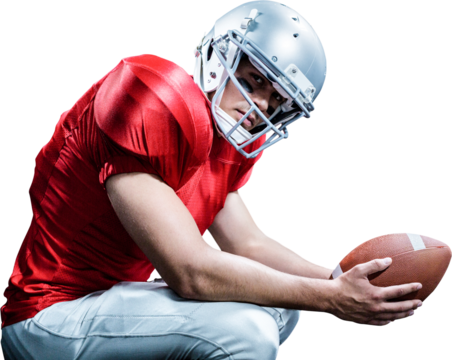 Portrait of American football player crouching while holding ball - Powered by Adobe