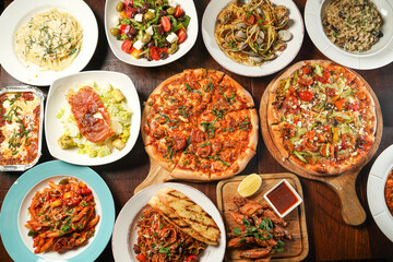 Fototapeta na wymiar Assortment of fastfood with pizza, Lasagne, Bolognese, chicken wings, greek and caesar salad, Fettuccini, Risotto, Spaghetti served in dish isolated on wooden table top view of italian fast food
