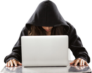 Female hacker sitting by laptop on table 