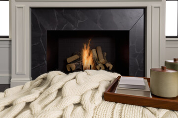 Cozy fireplace with knitted blanket 