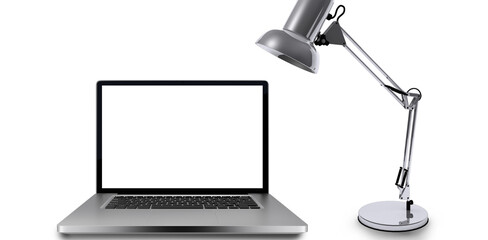 Laptop by table lamp