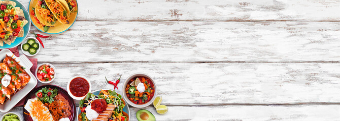 Mexican food corner border. Overhead view on a white wood banner background. Tacos, burrito plate, nachos, enchiladas, tortilla soup and salad. Copy space.