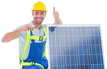 Handyman gesturing thumbs up while tightening solar panel
