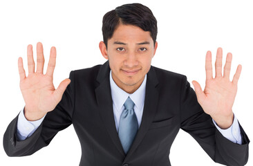 Smiling asian businessman holding hands up