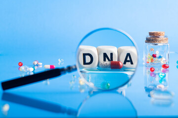 DNA pill on the background of a laboratory table with medicines and preparations. View through a...