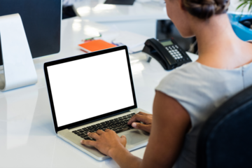 Woman working on laptop while sitting on chair