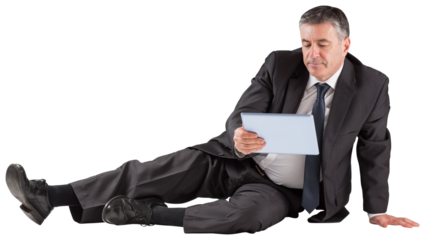 Mature businessman sitting using tablet