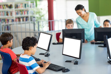 Children using computers as teacher teaching them