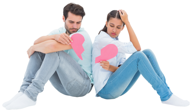Sad couple sitting holding two halves of broken heart