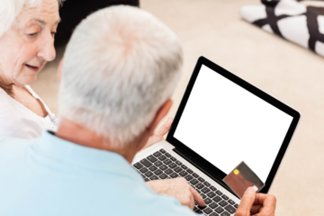 Focused senior couple using laptop
