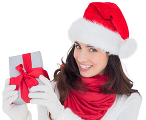 Excited brunette in santa hat showing gift