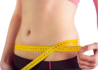 Woman measuring waist over white background