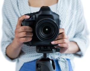 Mid section of woman holding digital camera 