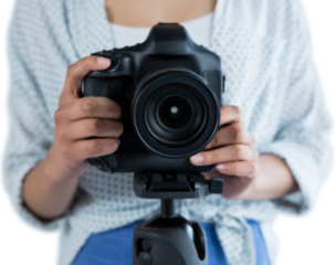 Mid section of woman holding digital camera 