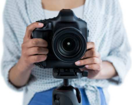 Mid section of woman holding digital camera 